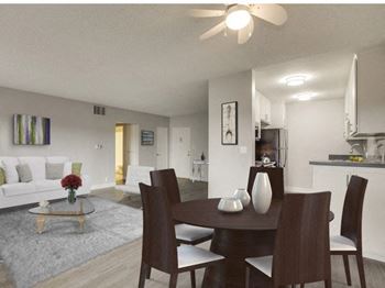 A modern dining room with a glass table and chairs.
